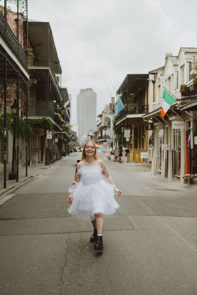 a bride at her destination wedding in New Orleans skipping down the French quarter