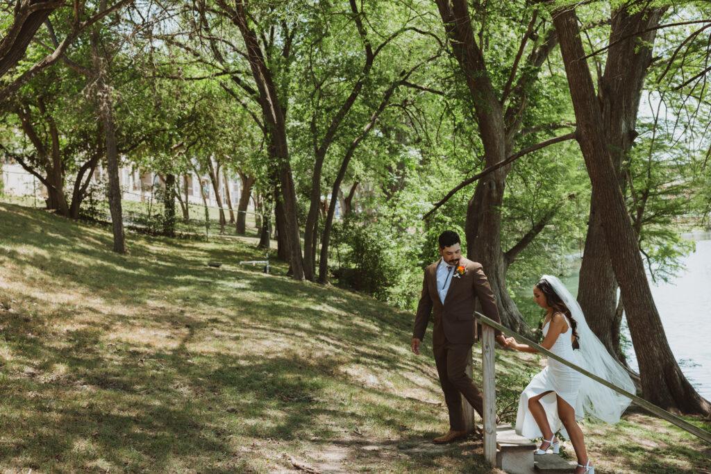 bride and groom walking up the stairs in the middle of the Texas Hill Country