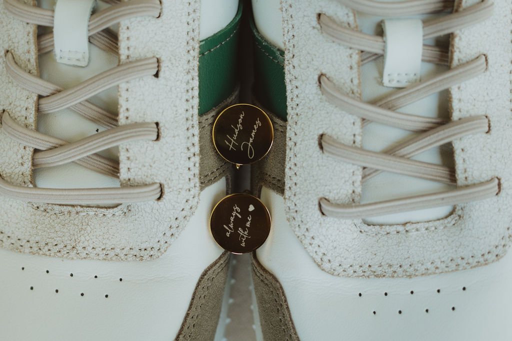 personalized cufflinks set in between a pair of men's sneakers