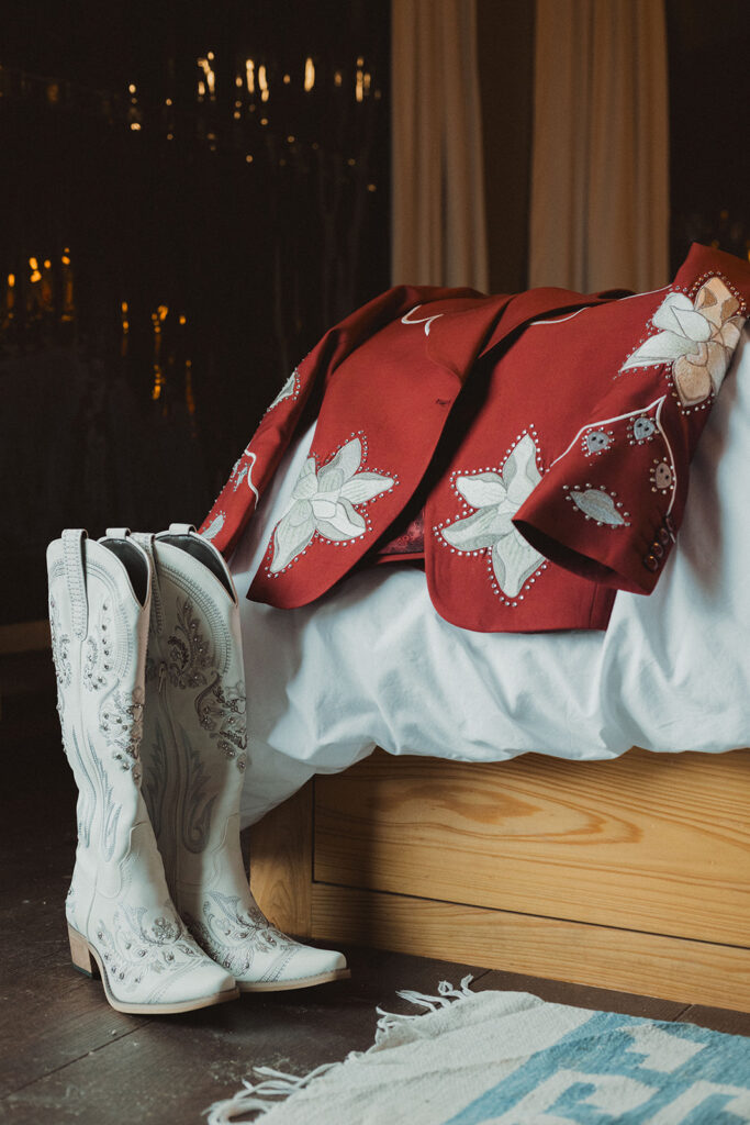 white bejeweled cowgirl boots with a red embroidered blazer