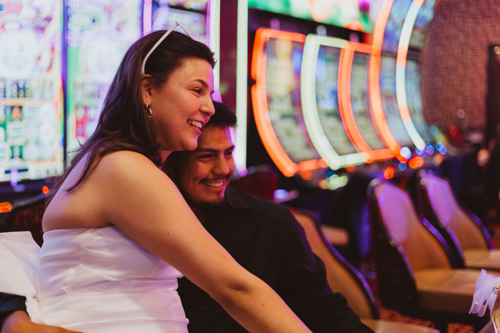 a couple laughs while playing a vegas slot machine together