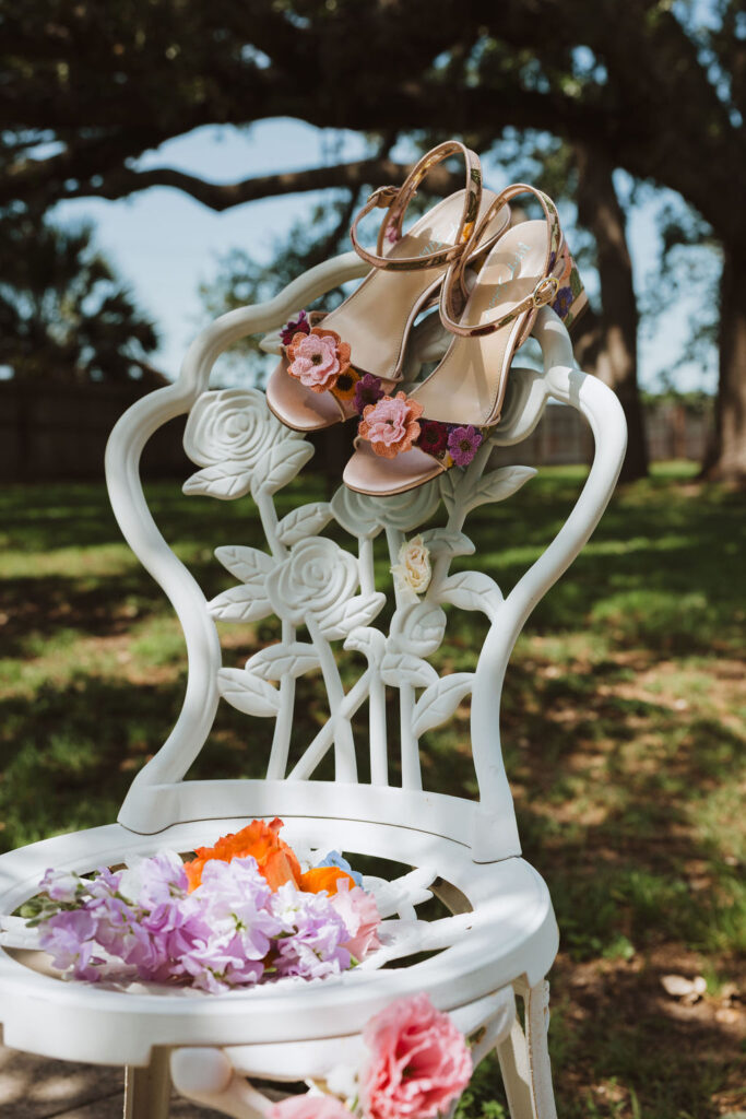 floral heels hand on an iron molded chair with other bright florals on it